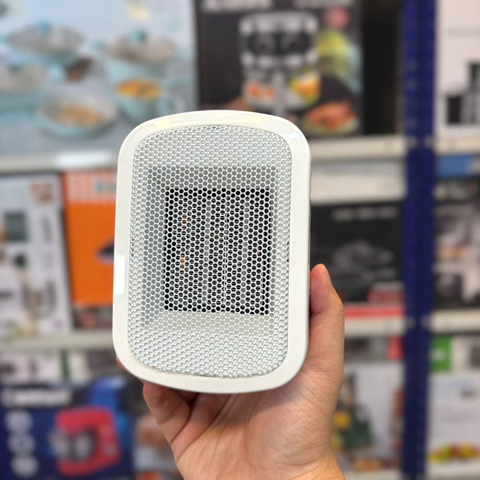 Mini electric heater size compared to a hand